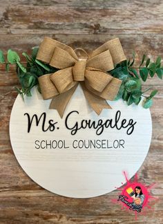 a wooden sign with a bow on it that says ms gougales school counselor