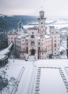 an aerial view of a castle in the snow