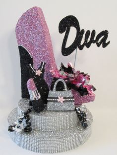 there is a glitter shoe and purse on top of a cake that says diya