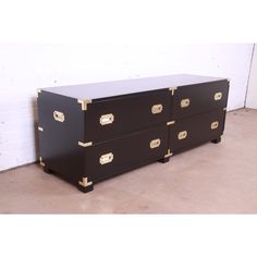 a black dresser with gold handles and drawers