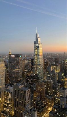 an aerial view of the city at night with skyscrapers lit up and lights on