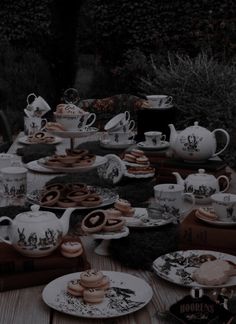 a table full of tea and cookies on plates