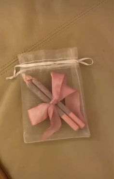 two pink bows are in a clear bag