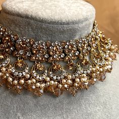 Choker only Stylish choker set adorned with sparkling golden and silver rhinestones and champagne beads, pearl detail  Measurements (Approx) Choker 1.5 inch  (Adjustable with sting) Ready to ship! Glamorous Gold Choker For Wedding, Glamorous Gold Bridal Necklace For Festive Occasion, Glamorous Gold Bridal Necklace For Party, Gold Rhinestone Choker For Party, Gold Bridal Necklace With Beads For Party, Gold Jeweled Bridal Necklace For Party, Glamorous Gold Bridal Necklace For Celebrations, Glamorous Gold Embellished Jewelry, Glamorous Embellished Gold Jewelry