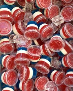 red, white and blue cupcakes are in a box with clear plastic lids