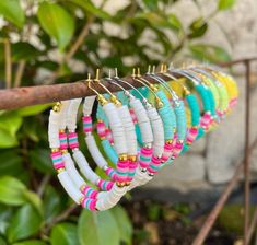 a bunch of bracelets hanging from a tree branch