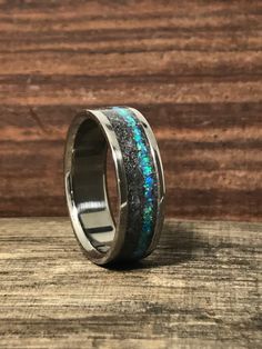 a wedding ring with blue and green fire opal inlays on the inside