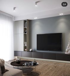 a living room with a christmas tree in the corner and a television on the wall