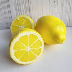 two lemons sitting next to each other on a table