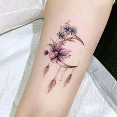 a woman's arm with a flower tattoo on it