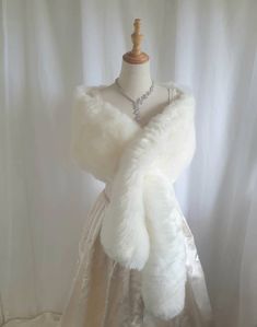 Link to Store - https://ivoryrosebridalau.etsy.com  In stock and ready to post  This listing is for a larger size wrap measuring 190cm which suits sizes 12 - 18 or if you prefer your wrap longer this is the size for you. This beautiful, Luxurious  Faux Fur Wrap is made from High Quality Faux fur and fully lined with a soft satin.  Includes Hook & Eye fastening & additional side slit. A must have to complete your wedding look! Adds a sophisticated touch to your wedding photo's, perfect for the br White Fur Wedding Dress, Fur Over Dress, White Fur Wrap, Wedding Dress With Fur Shawl, Fur Coat Wedding, Winter Wedding Dress Fur, White Fur Shawl, Fur Wedding Dress, Fur Bridal Wrap