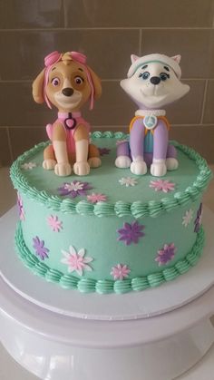 there is a cake that has two dogs on it