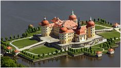 an aerial view of a large castle with red roof and orange domes on the top