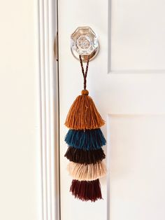 a tasseled doorknob hangs on a white door