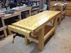 a workbench in a wood shop with tools on the table