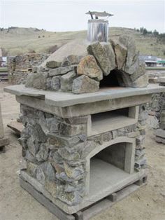 an outdoor oven made out of rocks and cement