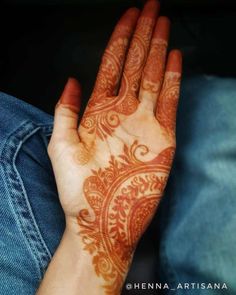 a woman's hand with henna on it