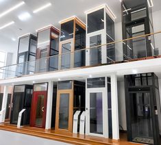 an empty building with multiple doors and windows on the second floor that have glass balconies above them