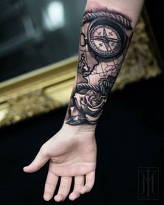 a person with a tattoo on their arm holding a clock and roses in front of them