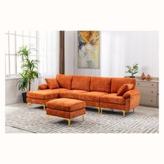 an orange couch and ottoman in a living room