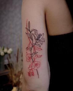 a woman with a flower tattoo on her arm