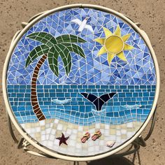 a mosaic table with a beach scene on it