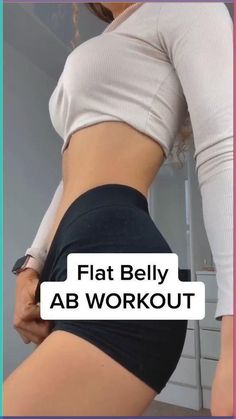 the woman is showing off her flat belly