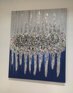 an abstract painting with lots of silver glitters on it's sides and blue background