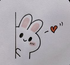 a drawing of a rabbit peeking out from behind a wall with a heart on it