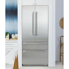 a stainless steel refrigerator in a white kitchen