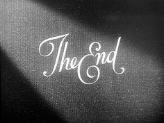 the end written in white ink on a black piece of paper with a light shining through it