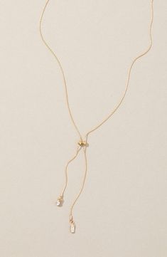 Sparkling cubic zirconia illuminate this dainty chain necklace that stands out on its own or in a layered style. 16" length; 2" extender; 1" shortest drop; 2" longest drop 14k-gold fill/cubic zirconia Made in the USA Drop Down Necklace, Delicate Chain Cubic Zirconia Backdrop Necklace As A Gift, Dainty Adjustable Lariat Necklace With Clavicle Chain, Adjustable Lariat Drop Necklace With Clavicle Chain, Backdrop Necklace With Long Drop And Adjustable Chain, Dainty Cubic Zirconia Lariat Necklace, Adjustable Long Drop Necklace With Delicate Chain, Adjustable Lariat Drop Necklace With Delicate Chain, Elegant Adjustable Lariat Charm Necklace