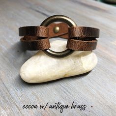 "This beautiful women's leather cuff is handmade with genuine leather. Super easy to put on, snaps with a single snap. No help needed. This leather statement bracelet features a 1\" o-ring. Choose from antique brass, matte nickel, shiny nickel or shiny brass rings and matching hardware. The genuine American tanned leather is 1/2\" wide. It will age beautifully and develops gorgeous character over time. ✦ 100% Handcrafted ✧ 5 Leather & Hardware Options ✦ High Quality Genuine American Tanned L Adjustable Vintage Cuff Bracelet With Wrist Strap, Adjustable Leather Cuff Bracelet With Bracelet Strap, Brown Leather Bracelet With Adjustable Band, Adjustable Vintage Bracelets, Handmade Adjustable Cuff Bracelet For Everyday Use, Adjustable Leather Cuff Bracelet With Waxed Finish, Adjustable Double Band Leather Bracelet, Adjustable Rustic Leather Bracelet, Adjustable Vintage Cuff Bracelet With Leather Strap