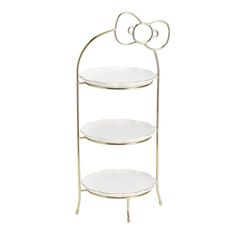 a three tiered metal shelf with white plates on the bottom and a hello mouse decoration