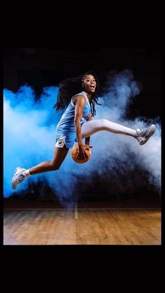 a female basketball player is jumping in the air