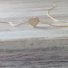 Cute gold necklace with a tiny heart charm hangs on a delicate 14k gold filled chain .This necklace is perfect for yourself, giving as a special gift.Necklace Measures Approximately 17"Tiny heard bead- 7 mmMade from 14k gold filled .If you would like this chain altered, please convo me. All my jewelry are packed in an elegant gift box.If you want to give it as a gift you can specify the address and I'll be happy to send it on your behalf. Dainty Adjustable Charm Necklace With Heart Charm, Heart-shaped Gold Necklace For Best Friend, Minimalist 14k Gold-filled Jewelry With Heart Charm, Dainty Everyday Heart Charm Necklace, Tiny Heart Pendant Charm Necklace For Everyday, Tiny Heart Pendant Charm Necklaces For Everyday, Dainty Hypoallergenic Charm Necklaces For Valentine's Day, Dainty Heart Beads Charm Necklace For Everyday, Dainty Everyday Charm Necklace With Heart Beads