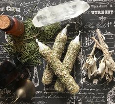 herbs and bottles on a table with writing