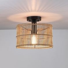 a light that is hanging from the ceiling in a room with white walls and flooring