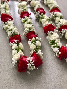 red and white flowers arranged in the shape of letters