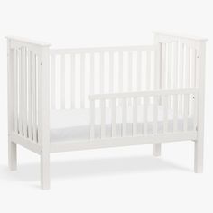 a white baby crib with no sheets on it