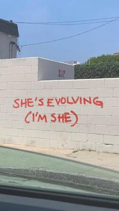 graffiti on the side of a building that says she's involving i'm she