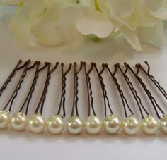 a close up of a hair comb with flowers in the background