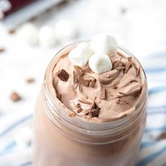 there is a chocolate drink with marshmallows in the top and on the side