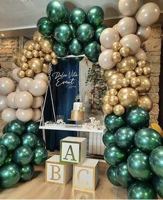 balloons are arranged in the shape of an arch with letters and numbers on it at a baby's first birthday party