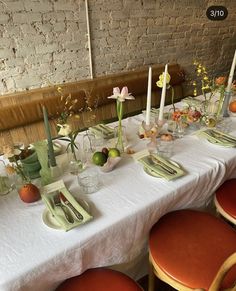 the table is set with flowers and candles