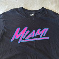 Never Worn 80s Color Way For Miami Great Condition! Miami Graphic Tee, Retro Pink Top With Text Print, 90s Inspired Black Text Print Top, 90s Inspired Black Tops With Text Print, 90s Inspired Black Top With Text Print, Retro Pink T-shirt For Streetwear, 90s Pink Logo Print Tops, 90s Inspired Black T-shirt With Graphic Print, 90s Inspired Black Graphic T-shirt