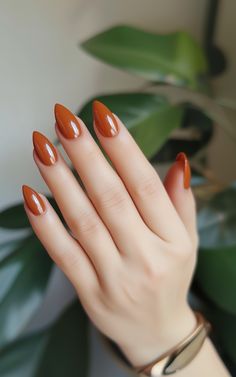 Is there any color that screams Fall more than burnt orange? It’s like having the changing leaves right on your fingertips! Burnt orange nails are the perfect way to channel those cozy autumn vibes without going overboard. Plus, they look good on literally everyone. Whether you're heading to the pumpkin patch or just want your nails to match your favorite oversized sweater, burnt orange is a go-to. Want to see how to rock this color with different finishes or even nail art? Head to our website for all the Fall nail inspiration you need this season! Burnt Orange Manicure, 40th Nails, Autumn Nails Burnt Orange, Almond Nails Burnt Orange, Burnt Orange Glazed Nails, Fall Orange Nails Acrylic, Fall Nails 2024 Burnt Orange, Burnt Orange Nails Fall, Autumn Leaves Nails