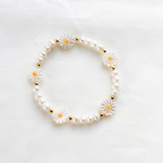 D E T A I L S --♡-- M A T E R I A L S:• Flower: 10 mm• Pearls : 5 mm• Ball Gold : 3 mm• It is made with stretchy elastic string Adjustable Daisy Bracelets For Spring, Delicate White Bracelets For Spring, White Delicate Bracelet For Spring, Delicate White Bracelet For Spring, Everyday White Beaded Bracelets For Spring, White Spring Festival Jewelry, White Daisy Bracelets As Gift, White Dainty Pearl Bracelet With Flower Shape, Dainty White Pearl Flower Bracelet