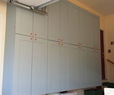 the kitchen cabinets are painted gray and have orange dots on them in order to match the wall color