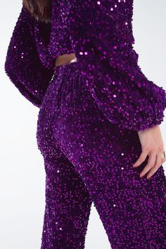 Add a touch of glamour to your party wardrobe with our Purple Wide Leg Sequin Pants, a must-have for those who love to stand out. All-Over Sequin Embellishment: These pants are adorned with shimmering purple sequins, providing a luxurious and eye-catching look perfect for any festive occasion. Elegant Wide-Leg Design: The flowy wide-leg style not only offers a modern and trendy look but also ensures comfort and freedom of movement. Convenient Side Pockets: The inclusion of side pockets adds a pr